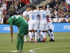 United States players celebrate past Bolivia's Jose Sagredo after a goal by Walker Zimmerman during the first half of an international friendly soccer match, Monday, May 28, 2018, in Chester, Pa.