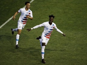 United States' Tim Weah (11) and Antonee Robinson (17) celebrate after Weah's goal during the second half of an international friendly soccer match, Monday, May 28, 2018, in Chester, Pa. The United States won 3-0.