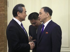 Chinese Foreign Minister Wang Yi is welcomed by North Korean Vice Foreign Minister Ri Kil Song on his arrival at Pyongyang Airport, North Korea Wednesday, May 2, 2018.