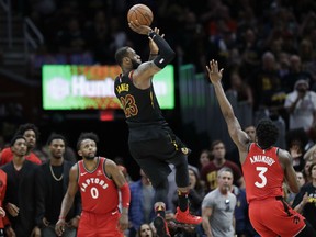 LeBron James of the Cavaliers hits the game-winning shot as Toronto Raptors' OG Anunoby and CJ Miles watch during the second half of Game 3 of their NBA second-round playoff series Saturday night in Cleveland. The Cavaliers won 105-103.