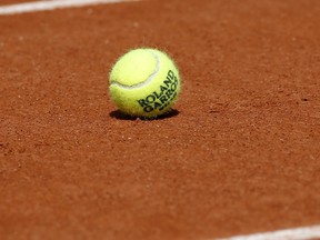 A tennis ball is pictured on a court at the Roland Garros stadium in Paris, Friday, May 25, 2018. The French Open tennis tournament starts Sunday.