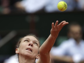 Romania's Simona Halep serves to Alison Riske of the U.S. during their first round match of the French Open tennis tournament at the Roland Garros stadium, Wednesday, May 30, 2018 in Paris.