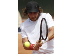 Argentina's Marco Trungelliti returns the ball to Australia's Bernard Tomic during their first round match of the French Open tennis tournament at the Roland Garros stadium, Monday, May 28, 2018 in Paris.