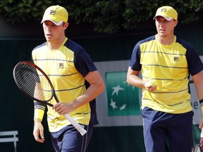 Britain's Ken Skupski and Neal Skupski, left, walk during their first round match of the French Open tennis tournament against Mike Bryan, of the U.S, and compatriot Sam Querrey at the Roland Garros stadium, Tuesday, May 29, 2018 in Paris.