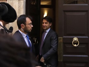 Italian Premier-designate Giuseppe Conte is approached by journalists as he leaves his home, in Rome, Thursday, May 24, 2018. Italy's President Sergio Mattarella Wednesday asked political neophyte Conte to try to form a government, giving the euroskeptic 5-Star Movement and anti-immigrant League a shot at running western Europe's first populist government.