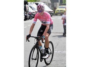 Britain's Chris Froome, in the pink jersey of the overall leader, makes his way to the start of the 20th stage of the Giro d'Italia cycling race, from Susa to Cervinia, Italy, Friday, May 25, 2018.