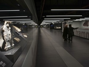 FILE - In this Thursday, April 6, 2017 file photo, an ancient Roman low relief with figures of Maenads dated between the first century B.C. and the first century A.D. are on display in the San Giovanni underground station of Rome's brand new third metro line. Romans, plagued by buses going aflame, have a new metro station. The stop was inaugurated Saturday, May 12, 2018 near Piazza San Giovanni, a busy interchange, allowing residents in Rome's eastern neighborhoods to take the C line to the edge of the capital's historic heart.