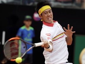 Japan's Kei Nishikori returns the ball to Spain's Feliciano Lopez during a match at the Italian Open tennis tournament, in Rome, Monday, May, 14, 2018.