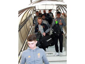 Liverpool's Mohamed Salah, center top, arrives with teammates at Fiumicino airport in Rome, Tuesday, May 1, 2018. Liverpool faces AS Roma in a Champions League soccer semifinal return match at the Olympic stadium in Rome on Wednesday.