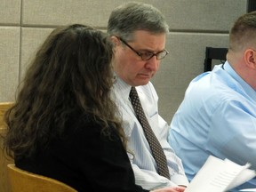 Mark Desimone, a former Arizona legislator charged with killing a man on an Alaska hunting and fishing trip in 2016, looks over documents with his attorney Deborah Macaulay during his trial on Thursday, May 10, 2018, in Juneau, Alaska. Macaulay said Thursday the shooting was an accident, not murder.