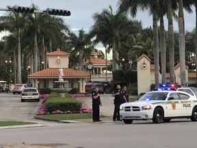 Police respond to The Trump National Doral resort after reports of a shooting inside the resort Friday, May 18, 2018 in Doral, Fla.  A man shouting about Donald Trump entered the president's south Florida golf course early Friday, draped a flag over a lobby counter and exchanged fire with police before being arrested, police said. One officer received an unspecified injury, officials said.