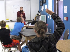 Patrick Brown instructs sixth-grade students in a lesson on water data at the Maine Consolidated School in Parks, Arizona, on Tuesday, May 2, 2018. The small district has bucked the trend in staying open during widespread teacher walkouts in Arizona.