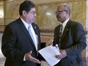 Kansas state Rep. Louis Ruiz, left, and Sen. David Haley, right, both D-Kansas City, confer during a break in negotiations on adoption legislation, Thursday, May 3, 2018, at the Statehouse in Topeka, Kan. The legislation would prevent the state from barring faith-based agencies from providing adoption services if they refuse for religious reasons to place children in LGBT homes.