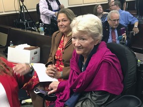 In this May 16, 2018 photo, Cathy Jordan, right, who has been suffering from ALS since 1987, looks on after completing testimony in Tallahassee, Fla., that would declare a smoking ban on medical marijuana unconstitutional in Florida. A Florida judge on Friday, May 25, 2018, ruled that the ban is unconstitutional.