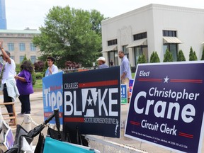 Campaign signs and political candidates greet visitors to the Pulaski County Courthouse Annex in Little Rock, Ark., for the end of the early voting period on Monday, May 21, 2018. Arkansas' primary and judicial general election occurs Tuesday, May 22, 2018.