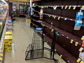 Supermarket shelves are stripped bare of bottled water in Salem, Ore., late Tuesday May 29, 2018, after officials warned residents that tap water was unsafe for children and the elderly due to an algae bloom. The head of Oregon's emergency management agency has apologized after a cryptic emergency alert was forced out to cellphones in and around Oregon's capital city, displaying the words "Civil Emergency" and "Prepare for Action," but carrying little other information.