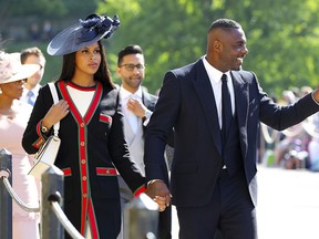 Idris Elba and Sabrina Dhowre arrive for the wedding ceremony of Prince Harry and Meghan Markle at St. George's Chapel in Windsor Castle in Windsor. He took over the role of DJ at the reception hosted for the newly married royal couple.