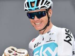 Chris Froome of Britain shows a cake with candle to celebrate his birthday, prior to the start of the 15th stage of the Giro d'Italia from Tolmezzo to Sappada, in Tolmezzo, Italy, Sunday, May 20, 2018. .