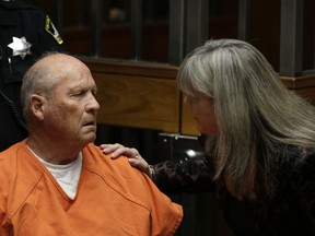FILE - In this Friday, April 27, 2018, file photo Joseph James DeAngelo talks with Sacramento County Public Defender Diane Howard, right, during his first appearance to face charges that include homicide and rape, in Sacramento County Superior Court in Sacramento, Calif. DeAngelo 72, appeared in court, Wednesday, May 2, 2018, with Howard who is asking the court to stop the Sacramento County District Attorney from further executing a search warrant.