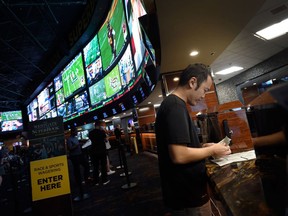 A customer makes a sports bet at the Race and Sports SuperBook at the Westgate Las Vegas Resort and Casino.