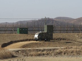 CORRECTS DATE - In this Feb. 15, 2018 photo, a South Korean military vehicle with loudspeakers is seen in front of the barbed-wire fence in Paju, near the border with North Korea. South Korea on Monday, April 30, 2018, said it will remove propaganda-broadcasting loudspeakers from the tense border with North Korea. The announcement came three days after the leaders of the two Koreas agreed to work together to achieve a nuclear-free Korean Peninsula and end hostile acts against each other along their border during their rare summit talks.