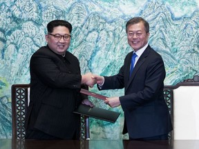 FILE - In this April 27, 2018 file photo, North Korean leader Kim Jong Un, left, and South Korean President Moon Jae-in shake hands after signing on a joint statement at the border village of Panmunjom in the Demilitarized Zone, South Korea. The two Koreas will hold a high-level meeting on Wednesday, May 16, 2018, to discuss setting up military and Red Cross talks aimed at reducing border tension and restarting reunions between families separated by the Korean War. (Korea Summit Press Pool via AP, File)