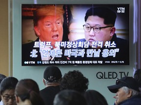 People watch a TV screen showing images of U.S. President Donald Trump, left, and North Korean leader Kim Jong Un during a news program at the Seoul Railway Station in Seoul, South Korea, Friday, May 25, 2018. North Korea said Friday that it's still willing to sit down for talks with the United States "at any time, at any format" just hours after President Donald Trump abruptly canceled his planned summit with the North's leader Kim Jong Un. The signs read " Trump abruptly canceled his planned summit with the North Korea."