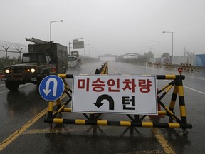 A South Korean military vehicle crosses Unification Bridge, which leads to the demilitarized zone, near the border village of Panmunjom in Paju, South Korea, Wednesday, May 16, 2018. North Korea on Wednesday canceled a high-level meeting with South Korea and threatened to scrap a historic summit next month between U.S. President Donald Trump and North Korean leader Kim Jong Un over military exercises between Seoul and Washington that Pyongyang has long claimed are invasion rehearsals. The barricade reads: "Vehicles disapproved."
