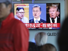 A TV screen shows images of U.S. President Donald Trump, right, South Korean President Moon Jae-in and North Korean leader Kim Jong Un, left, during a news program at the Seoul Railway Station in Seoul, South Korea, Friday, May 25, 2018. North Korea said Friday that it's still willing to sit down for talks with the United States "at any time, at any format" just hours after President Donald Trump abruptly canceled his planned summit with the North's leader Kim Jong Un. The signs read " Hope to see you again someday."