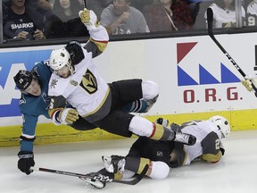 San Jose Sharks left wing Marcus Sorensen, from Sweden, left, and Vegas Golden Knights defenseman Colin Miller fall over Cody Eakin during the first period of Game 3 of an NHL hockey second-round playoff series in San Jose, Calif., Monday, April 30, 2018.