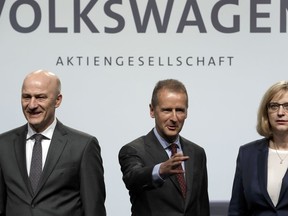 Herbert Diess, left, CEO of the Volkswagen stock company, and the members of the Board of Management of Volkswagen, Hiltrud Dorothea Werner, right, and Frank Witter, left, pose for the media prior to the shareholder's meeting in Berlin, Germany, Thursday, May 3, 2018.