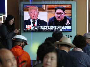 Images of U.S. President Donald Trump and North Korean Leader Kim Jong-Un appear on a TV screen at the Seoul Railway Station in South Korea, during a news program on May 29, 2018.