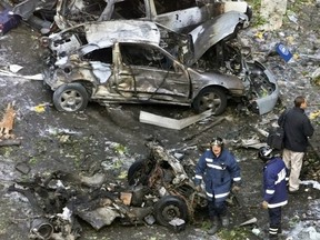 In this Nov. 6, 2001 file photo, firefighters work at the scene of a car bomb in Madrid.