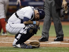 Tampa Bay Rays catcher Wilson Ramos doubles over after getting hurt on a pitch from Austin Pruitt during the third inning of a baseball game against the Boston Red Sox Tuesday, May 22, 2018, in St. Petersburg, Fla. Ramos left the game.