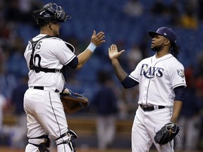 Tampa Bay Rays catcher Wilson Ramos (40) celebrates with relief pitcher Alex Colome after the team's 6-3 win over the Boston Red Sox in a baseball game Thursday, May 24, 2018, in St. Petersburg, Fla.