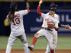 Boston Red Sox right fielder Mookie Betts celebrates with Hanley Ramirez (13) after the Red Sox defeated the Tampa Bay Rays 4-2 during a baseball game Tuesday, May 22, 2018, in St. Petersburg, Fla.