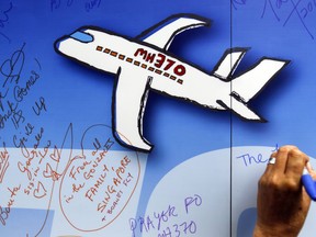 FILE - In this March 6, 2016, file photo, well wishes are written on a wall of hope during a remembrance event for the ill fated Malaysia Airlines Flight 370 in Kuala Lumpur, Malaysia. Australia said it held out hope Malaysia Airlines Flight 370 would one day be found as the last search of the seabed in the remote Indian Ocean where it was believed to have been lost was scheduled to end on Tuesday, May 29, 2018.