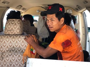 An injured man sits inside a vehicle in Muse, northern Shan state, Myanmar Saturday, May 12, 2018. Myanmar officials say an ethnic rebel group has launched an attack against the country's military in the northern town, causing casualties.