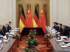 China's Premier Li Keqiang, second right, and German Chancellor Angela Merkel, left, attend a meeting at the Great Hall of the People in Beijing, Thursday, May 24, 2018.