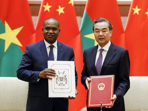 China's Foreign Minister Wang Yi, right, and Burkina Faso Foreign Minister Alpha Barry attend a signing ceremony establishing diplomatic relations between the two countries in Beijing Saturday, May 26, 2018.