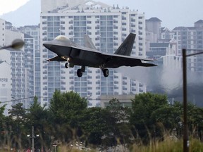 FILE - In this May 16, 2018, file photo, a U.S. F-22 Raptor stealth fighter jet lands as South Korea and the United States conduct the Max Thunder joint military exercise at an air base in Gwangju, South Korea. North Korean media are stepping up their rhetorical attacks on South Korea and joint military exercises with the United States, warning that a budding detente could be in danger. State media unleashed three strongly worded commentaries Tuesday, May 22, 2018, slamming Seoul and Washington for the maneuvers and demanding Seoul take action against defectors it claimed were sending anti-North Korea propaganda leaflets across the border.