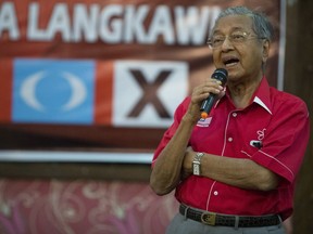 FILE - In this Friday, April 27, 2018, file photo, former Malaysian strongman Mahathir Mohamad speaks at a local community in Langkawi, Malaysia. In an unlikely comeback, he's switched sides in Malaysian politics, coming out of retirement to unite an opposition that's seeking to end his former party's 60-year hold on power and oust his protege, Prime Minister Najib Razak, in May 9 elections.