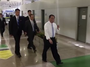 In this image made from video, Kim Yong Chol, in white, a former military intelligence chief who is now Kim Jong Un's top official on inter-Korean relations, walks upon arrival at Beijing airport in Beijing Tuesday, May 29, 2018. He was at North Korean leader Kim Jong Un's side at the table in last weekend's North-South summit, and had been a prominent senior official in other important talks. It was not possible to confirm the reason for his visit to Beijing, or if he would be traveling on to another destination. (AP Photo)