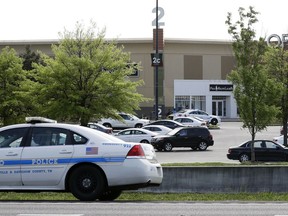 A police car sits outside Opry Mills mall Thursday, May 3, 2018, in Nashville, Tenn. Nashville police said a suspect was taken into custody after a person was shot inside the mall. The mall was evacuated after the gunfire was reported. One person was taken to a hospital and was reported to be in critical condition.