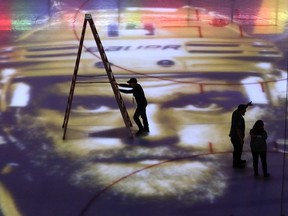 An image of Nashville Predators defenseman Mattias Ekholm is projected onto the ice as workers prepare Bridgestone Arena for Game 7 of an NHL hockey second-round playoff series between the Predators and the Winnipeg Jets on Thursday, May 10, 2018, in Nashville, Tenn.
