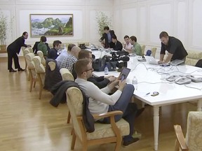 This image made from video shows foreign journalists and North Korean internet connection staff at Kalma Hotel in Wonsan, North Korea, Tuesday, May 22, 2018. A small group of foreign journalists arrived in North Korea on Tuesday to cover the dismantling of the country's nuclear test site later this week, but without South Korean media initially also scheduled to participate. Pyongyang is allowing the limited access to the site to publicize its promise to halt underground tests and launches of intercontinental ballistic missiles. It unilaterally announced that moratorium ahead of a summit between leader Kim Jong Un and President Donald Trump scheduled for June 12 in Singapore. (AP Photo)