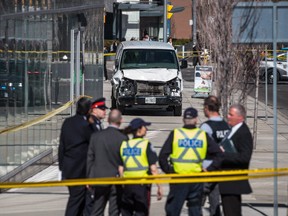 Police are seen near the damaged van used in the attack that killed 10 people and injured 16.