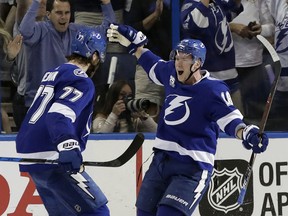 Tampa Bay Lightning left wing Ondrej Palat (18) celebrates with defenseman Victor Hedman (77) after Palat scored against the Washington Capitals during the first period of Game 5 of the NHL Eastern Conference finals hockey playoff series Saturday, May 19, 2018, in Tampa, Fla.