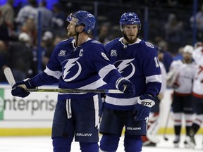 Tampa Bay Lightning center Steven Stamkos (91) and center J.T. Miller (10) leave the ice after losing 4-2 to the Washington Capitals during Game 1 of the NHL Eastern Conference finals hockey playoff series Friday, May 11, 2018, in Tampa, Fla.