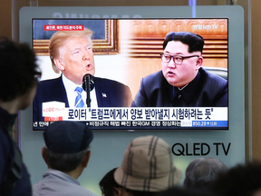 People in Seoul, South Korea, watch a TV news item discussing U.S. President Donald Trump and North Korean leader Kim Jong Un on May 18, 2018.